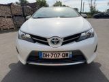 the front of a white toyota corollant parked in a parking lot