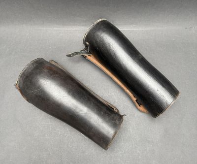 two leather sheaths that are sitting on a table