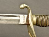a close up of a sword with a gold handle