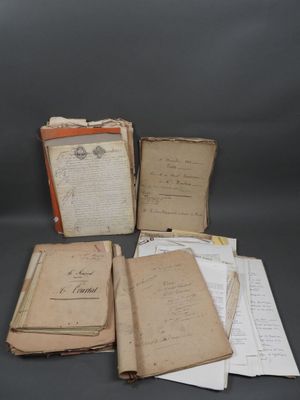 several old books are stacked on top of each other on a table