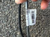 a hand that is holding a wire with a barcode on it