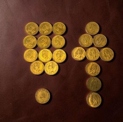 a lot of gold coins on a brown table