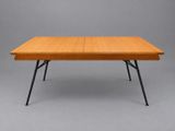 a table with a wooden top and black legs