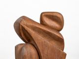 sculpture made of wood on a white pedestal