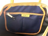 the inside of a blue and brown bag with a zipper on it