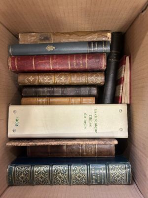 many books in a box that are stacked together