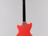 an electric guitar hanging from a string on a wall