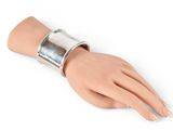 silver metal cuff bracelet on a mannequin hand on a white background