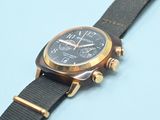 an image of a close up of a wrist watch on a blue surface