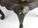 a bronze statue of a man on a horse on a table