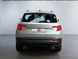 the rear of a silver car is parked in a large room
