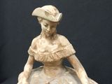 a statue of a woman sitting on top of a table
