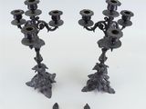pair of black metal candlesticks with birds on them