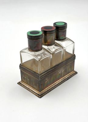 three salt and pepper shakers sitting on top of a wooden box