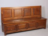 a wooden bench that is sitting next to a chair