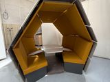une cabine jaune et noire dans un bâtiment équipé d'un lavabo