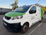 a green and white van that is parked in a parking lot