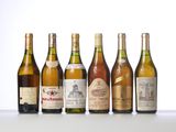 several bottles of wine are lined up on a table
