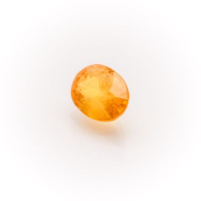 an oval shaped yellow sapphire stone on a white background