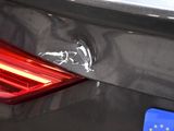 a close up of a car ' s tail light with a sticker on it