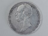 an old silver coin with a man ' s face on it