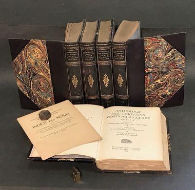 several old books are sitting on a table with a book open