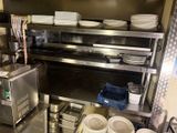 a kitchen with a lot of dishes on the shelves