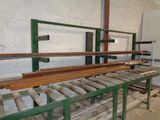 a long line of wooden planks on a conveyor belt in a warehouse