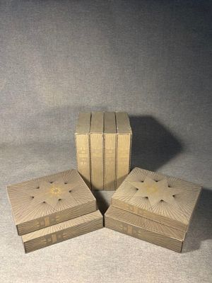 three wooden boxes are stacked on top of each other on a table