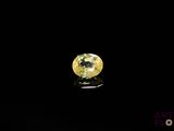 a close up of a yellow diamond on a black surface