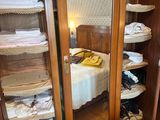 an image of a bedroom with a closet full of clothes