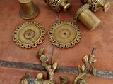 a lot of brass items on the floor next to each other