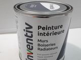 a can of paint sitting on a white table