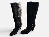 two pairs of black and white boots on a white surface