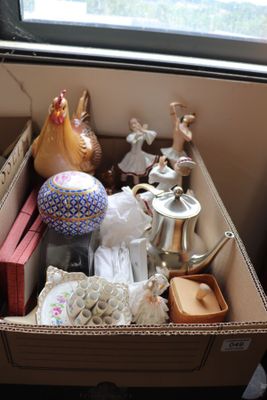 a box full of items sitting on the floor by a window