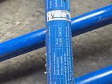 a close up of a blue pipe on the ground