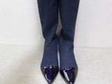 pair of blue high heeled boots sitting on a white surface