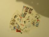 a pile of stamps sitting on a table next to a pair of scissors