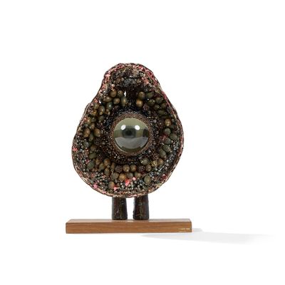 an image of a stone sculpture on a wooden stand