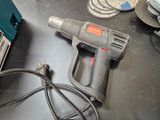 a drill that is sitting on a table next to other tools