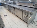 a kitchen with a lot of stainless steel counter tops