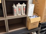 many boxes and cans of paint sitting on a shelf