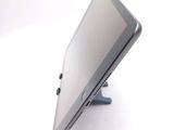 a tablet computer sitting on a stand on a white surface