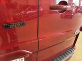 a close up of a red truck with a license plate