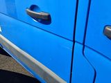 a blue van that is parked in the parking lot