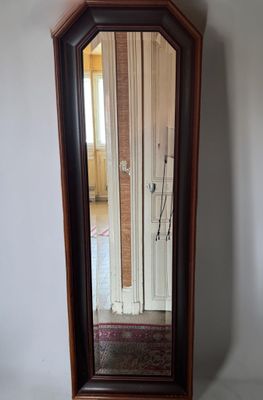 a mirror that is sitting on the floor in front of a wall