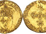 a gold coin with a crown on top of it