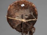 a close up of a piece of wood with a piece of string around it
