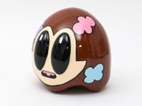 a brown toy with a cartoon face on it ' s head