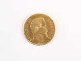 a gold coin with a picture of a man ' s head on it